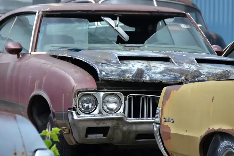 Old rusty scrap car awaiting free towing in Alberta