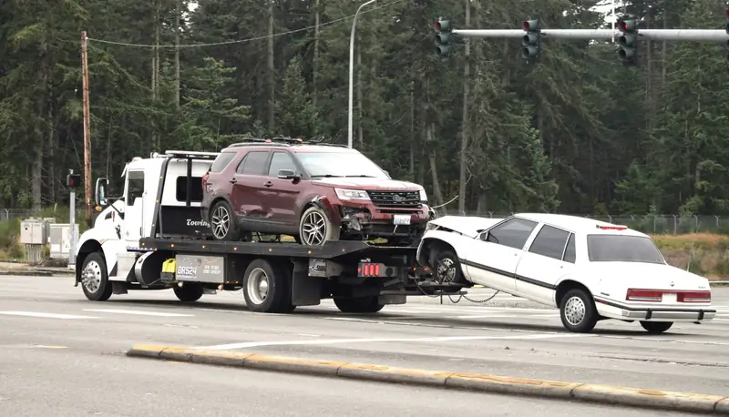 Flatbed tow truck providing free junk vehicle towing across Alberta